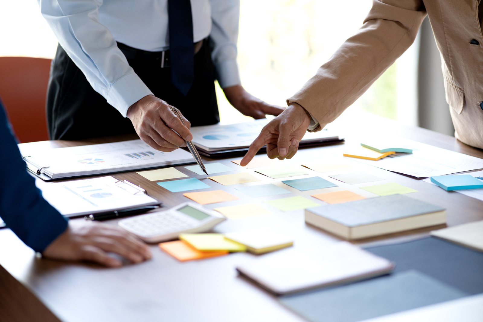 The management team is standing in a brainstorming session selecting ideas